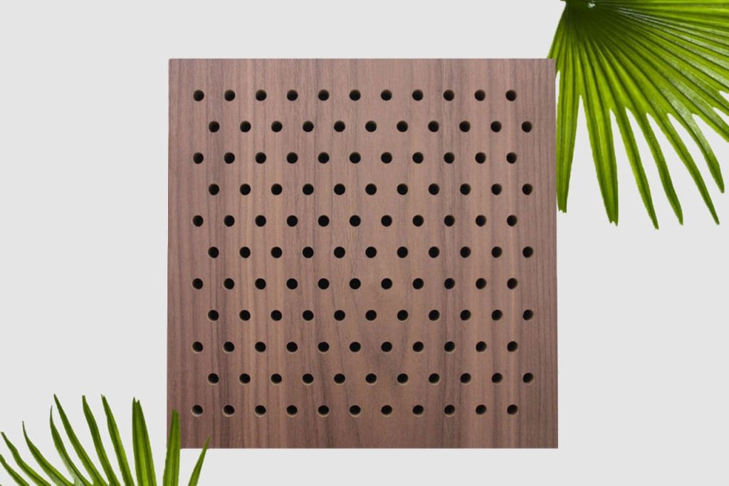 A square Timberix Acoustic Panel Products wooden panel with a grid of evenly spaced round holes, set against a white background, with green palm leaves partially framing the top right and bottom left corners.